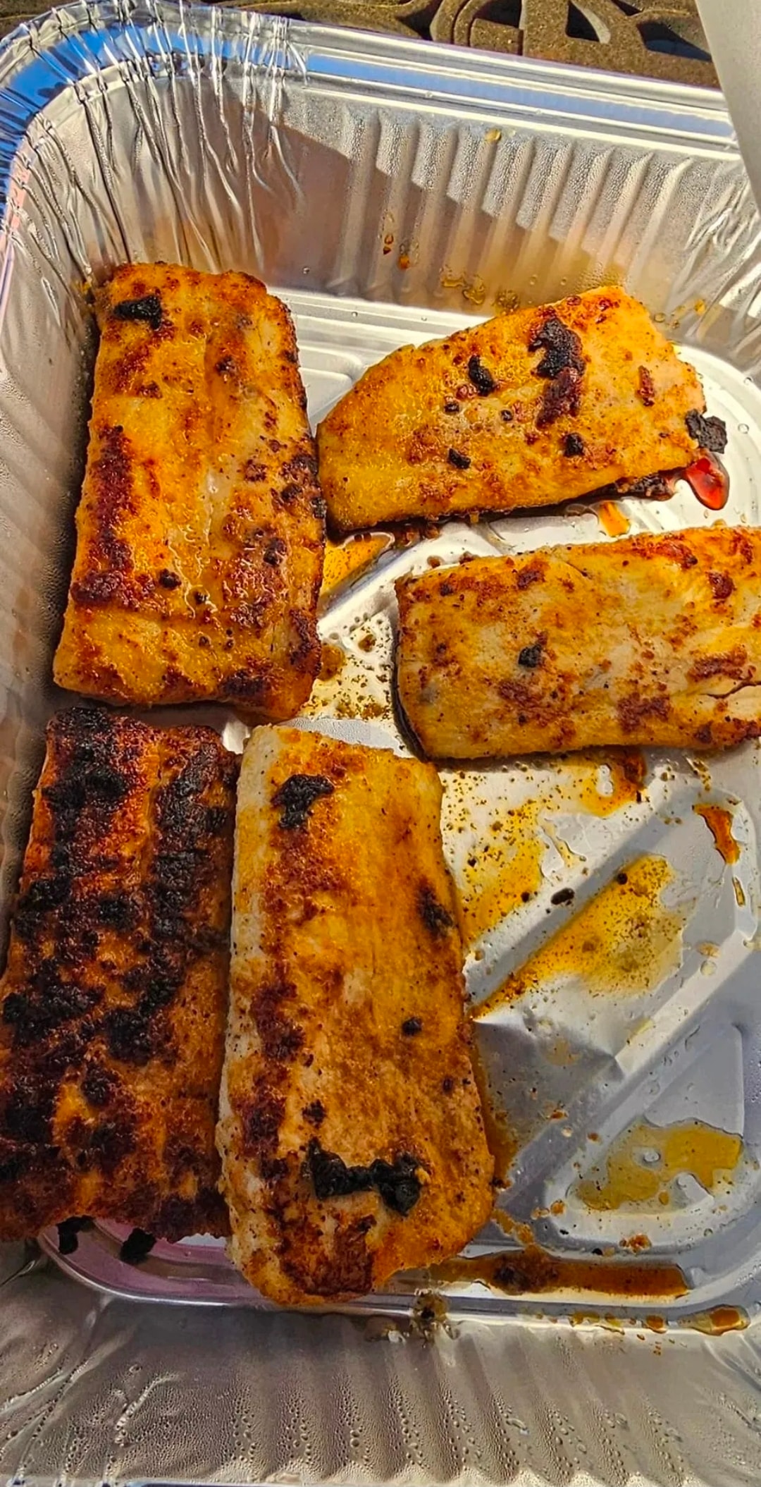 Blackened and seasoned grilled fish fillets, hot off the grill