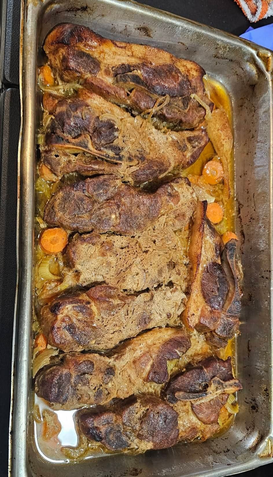 Slow-roasted smothered pork with carrots and onions, fresh from the oven